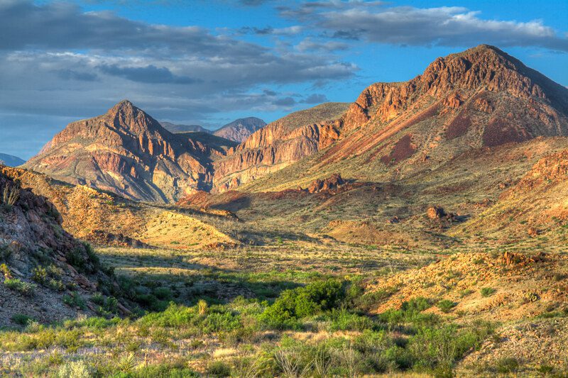 The southernmost mountain range in the United States is the Chisos Mountains and are found in West Texas, completely surrounded by the Chihuahuan Desert. This ancient volcanic mountain range is found completely with the borders of Big Bend National Park along the US-Mexico border. This incredible view was photographed on a late spring afternoon as the sun began to set in the "golden hour".